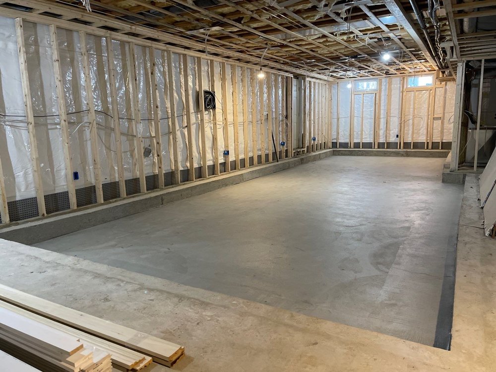 Basement waterproofing Akron drainage channel along a framed basement wall