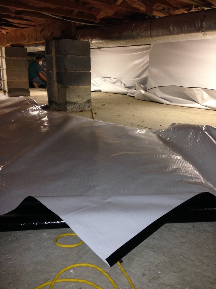 Crew laying a crawl space liner in Wallhaven on a basement waterproofing job in Akron